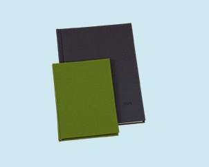 Green and gray weekly planner lying on top of each other